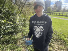 a person wearing a hoodie that says the skulls