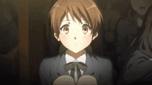 a girl with short brown hair is wearing a suit and tie