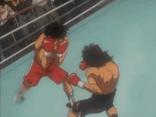 two boxers are fighting in a boxing ring .