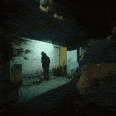 a person standing in a dark room with a sign that says ' scuba ' on it