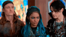a group of three people standing next to each other .