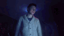 a person is standing in a dark room with a blue light shining on them