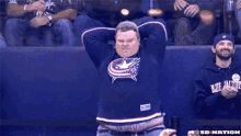 a man in a sb nation hoodie holds a flag