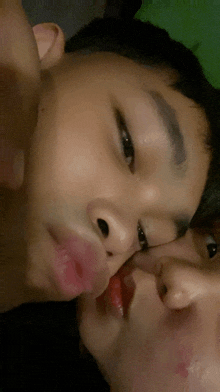 a boy and a girl kissing each other on the cheeks