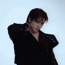 a man wearing a black jacket and a black shirt