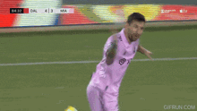 two soccer players in pink jerseys are celebrating a goal .