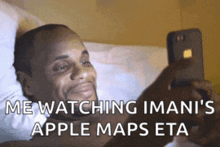 a man is laying on a bed looking at his phone with the caption " me watching iman 's apple maps eta "