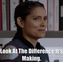 a woman in a black jacket with a patch that says ' look at the difference it 's making '
