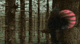 a computer generated image of a forest with trees and a red ball in the middle