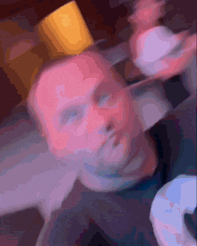 a blurry picture of a person 's face with a yellow object on top of it