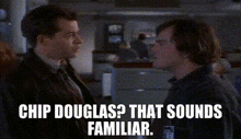 two men are standing next to each other in a room and one of them is talking to the other .