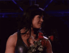 a man and a woman are standing next to each other holding roses ..