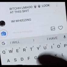 a man is sitting on a couch looking at his phone