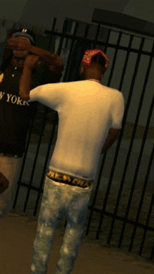a man in a new york shirt stands next to another man