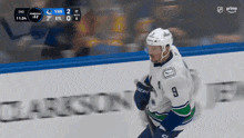 a hockey player with the number 9 on his jersey is running on the ice