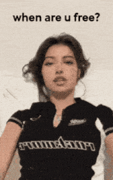 a woman is wearing a black shirt that says ' when are u free ' on it