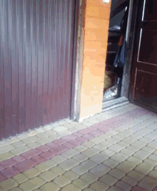 a doorway with a brick floor and a brick wall
