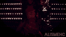 a woman in a red dress with the word alismehc on the bottom right