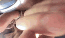 a close up of a person 's hand with a ring on