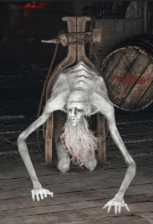 a statue of a man with a beard is crawling on the ground