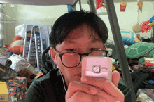 a person taking a picture of themselves with a pink phone