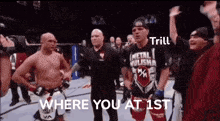 a man in a metal hulisha shirt is standing in a boxing ring