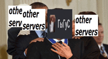 a man in a suit and tie is being hugged by another man with a sign that says other servers