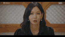 a close up of a woman 's face with the sbs logo in the corner