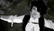 a black and white photo of a woman wearing a pirate costume and eye patch .