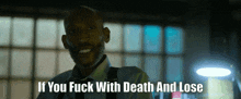 a man in a suit and tie is smiling with the words if you fuck with death and lose below him