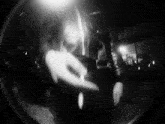 a black and white photo of a person dancing in a dark room