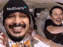 a man wearing a beanie that says multivers x smiles next to elon musk