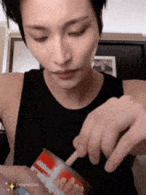 a man is opening a can of french fries with a toothpick in it