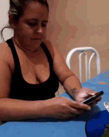 a woman with a tattoo on her arm is using a cell phone