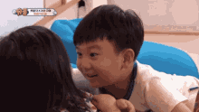 a boy and a girl are looking at each other .
