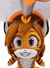 a stuffed animal of a tiger with a crown on its head