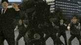 a man in a suit is holding a hammer in front of a group of men in suits