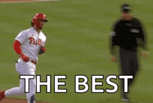 a baseball player is running on a baseball field with the words `` the best '' written on the field .