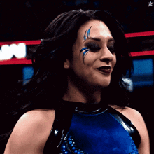 a woman in a blue and black outfit with a star in the background