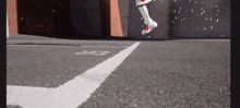 a person is jumping in the air while wearing a pair of white sneakers .