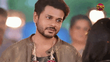 a man with a beard is looking at a woman in front of a sign that says ' dharma '