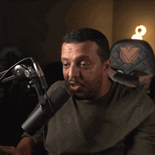 a man speaking into a microphone with a kappa shirt on