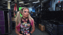a woman stands in a room with a purple box that says ' pieces backstage lighting ' on it