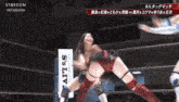 a woman in a wrestling ring with a sign that says ' ails entertainment ' on it