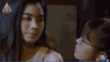 a woman is pointing at another woman with the number 7 on the bottom