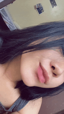 a woman with long black hair is taking a selfie