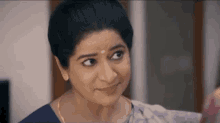 a close up of a woman making a funny face and smiling .