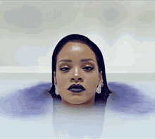 a woman in a bathtub with her head sticking out of it