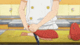 a person is cutting a red fish with a knife on a cutting board