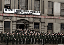 a large group of men standing in front of a building that says transport and general workers union